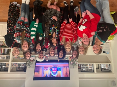 The members of Women in Emergency Medicine group poses for a picture in Christmas sweaters.